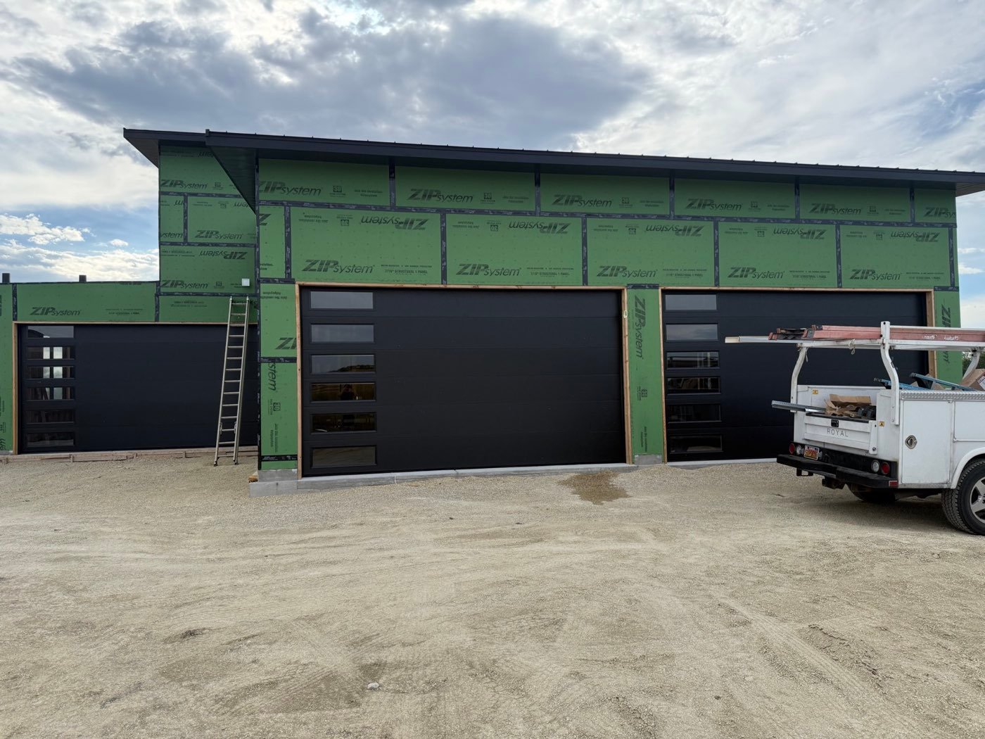 Three black modern doors on a shop under construction
