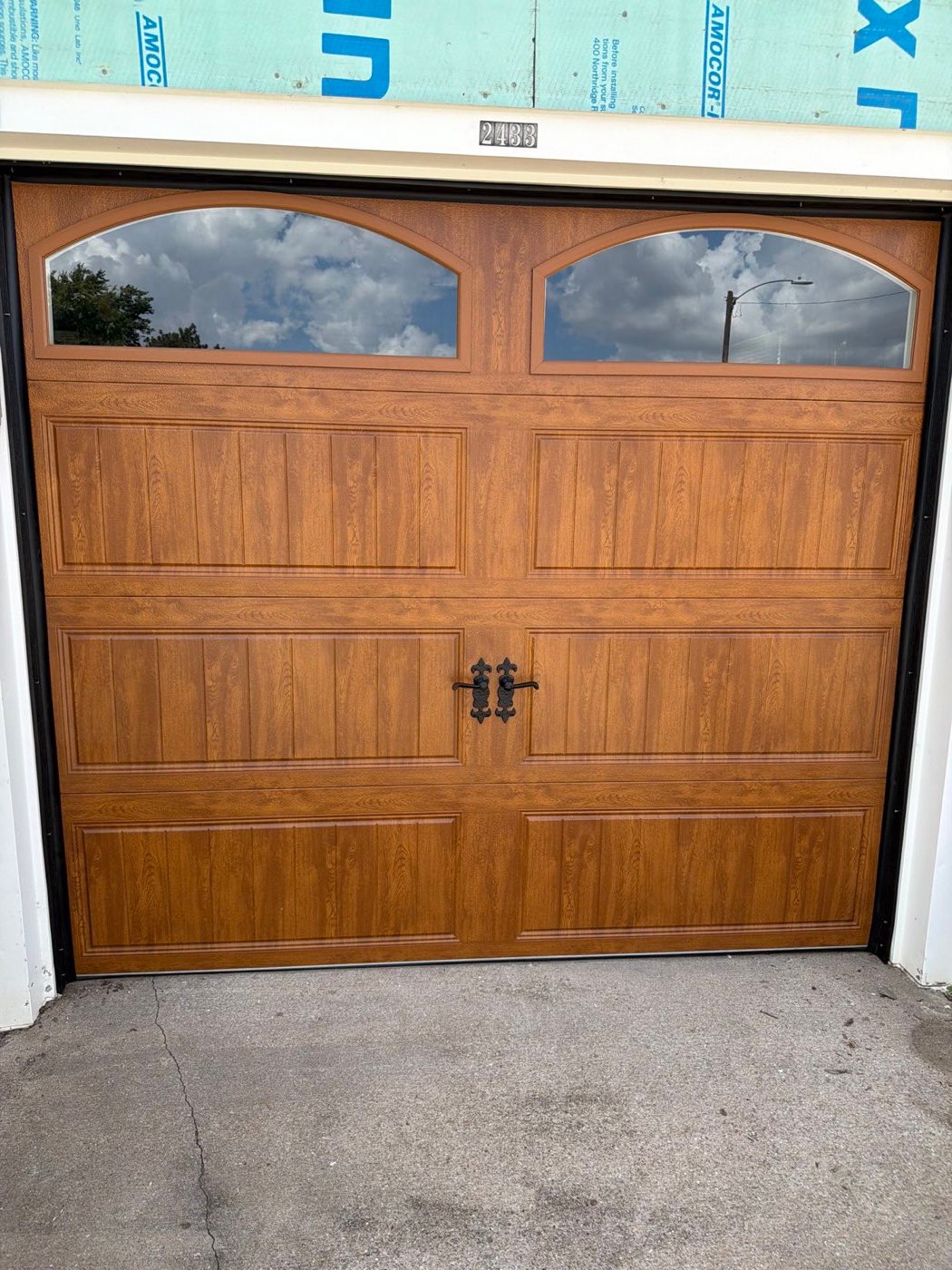 Oak wood-look garage door with arched windows